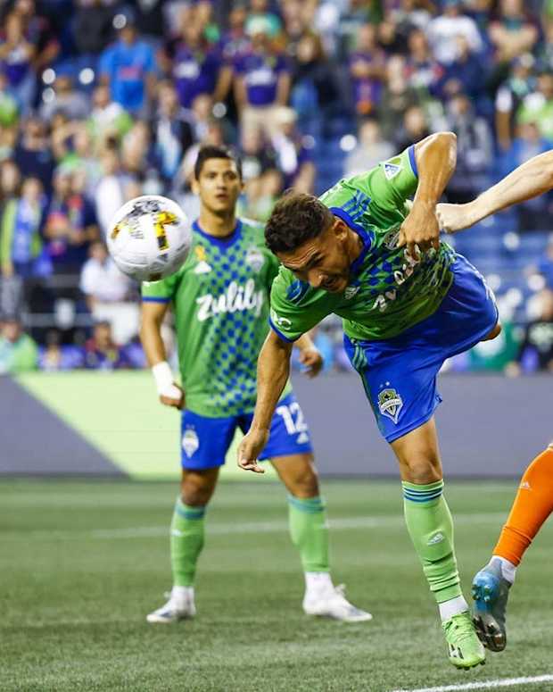 Sep 27, 2022; Seattle, Washington, USA; Seattle Sounders FC midfielder Cristian Roldan (7) misses a potential game-winning header against FC Cincinnati defender John Nelson (3) on the final play of the second half at Lumen Field. Mandatory Credit: Joe Nicholson-USA TODAY Sports